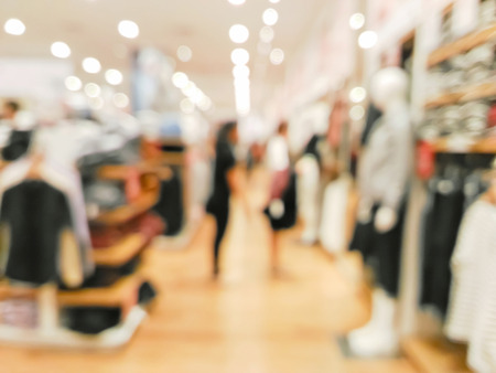 Blurred customers in a clothing shop in shopping mallの写真素材