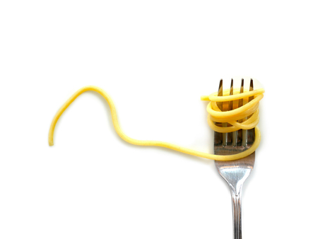Cooked capellini spaghetti with fork isolated on white background. Copy space.の写真素材