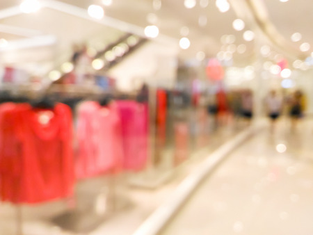 Blurred clothing storefront window display in shopping center backgroundの写真素材