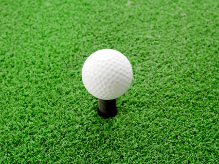 Golf ball on tee in driving range. Close up.の写真素材