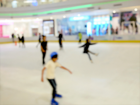 Blurred people enjoy ice skating on ice rinkの写真素材