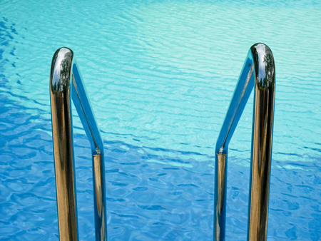 Swimming pool handrails and ladders in resortの写真素材