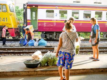 Bangkok, Thailand - May 19, 2018: People carry goods such as fresh fish, vegetables and fruit from the train for selling at the market nearbyのeditorial素材