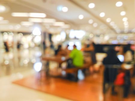Blurred people sitting in a cafe in shopping mallの写真素材