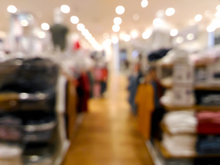Blurred colorful clothing shop with bokeh light in shopping mallの写真素材
