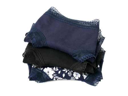 Stack of folded sexy women's panties underwear isolated on white backgroundの写真素材
