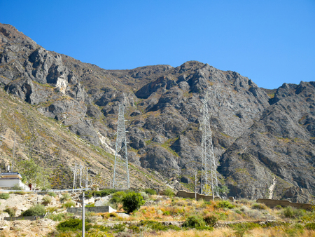 High power electrical transmission tower on the mountain in rural areaの写真素材