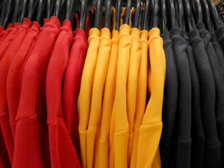Sweaters clothes hanging in boutique shop in shopping mall