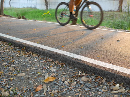 Motion blur people cycling in bike lane in the parkの写真素材