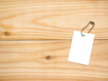 Blank price tag label on wooden table with copy spaceの写真素材