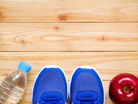 Exercise and fitness equipment with red apple on wooden  in the gym with copy space. Top view. Wellness conceptの写真素材
