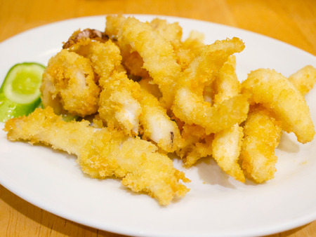 Crispy fried calamari in a white plateの写真素材