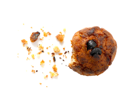 Burned cornflake and raisin cookie with crumb isolated on whiteの写真素材