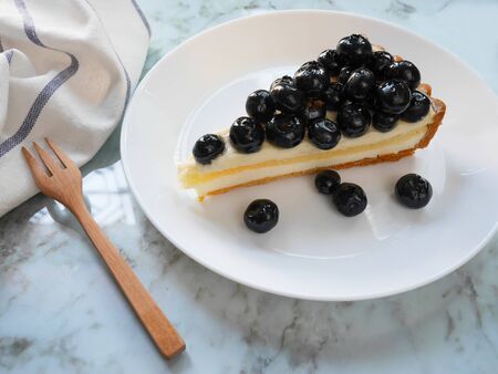 Blueberry tart on a white plateの写真素材