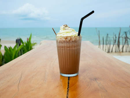 Chocolate frappe or chocolate ice blended with whipped cream on wooden tableの写真素材