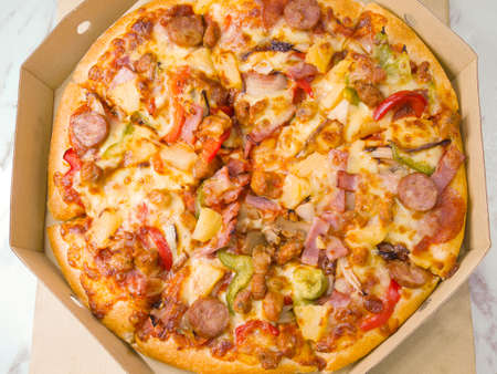 Pizza in takeaway cardboard boxの写真素材