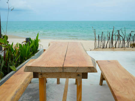 Wooden table and benches in the cafe by the sea
