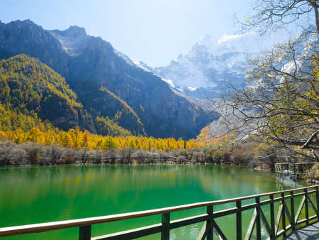 Pearl Lake or Zhuoma La Lake and snow mountain in autumn in Yading Nature reserve, Sichuan, China. Beautiful nature landscape.の写真素材