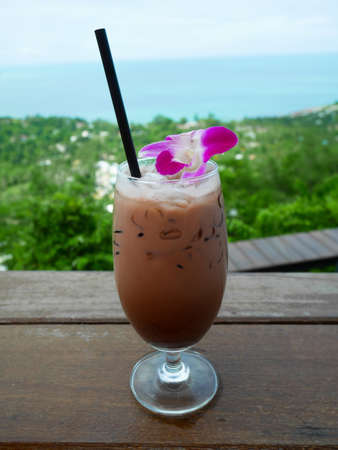 A glass of Iced chocolate on wooden table in cafeの写真素材