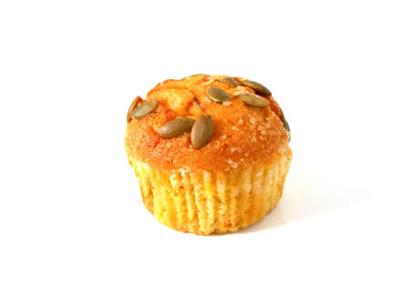 Pumpkin muffin topped with pumpkin seeds isolated on white backgroundの写真素材