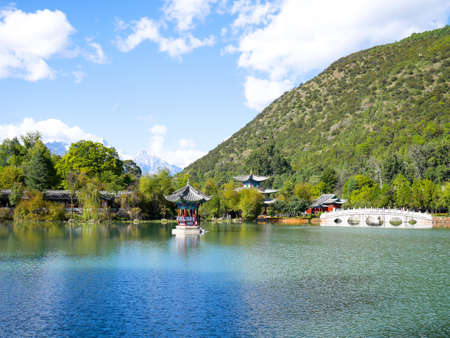 Scenery of Black Dragon Pool in Jade Spring Park (Yu Quan Gong Yuan) with Jade Dragon Snow Mountain in the background.のeditorial素材