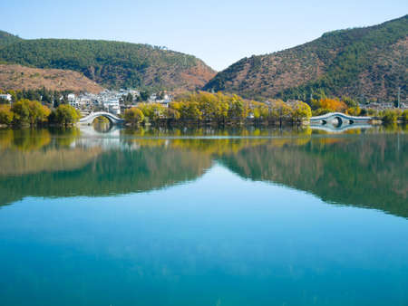 Qingxi reservoir with beautiful bridges in Lijiang, Yunnan, Chinaの写真素材