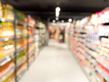 Blurred goods on shelves at supermarketの写真素材