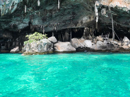 Viking cave for harvesting bird nests with crystal clear water in Krabi, Thailandの写真素材