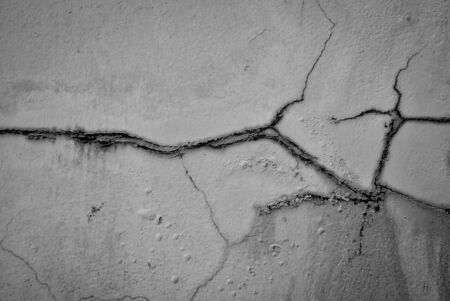 grey grunge wall with cracksの写真素材