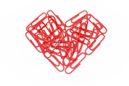 paper clips arranged in heart shape on white background.の写真素材