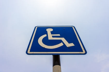 Closeup of handicapped parking place sign over blue skyの写真素材