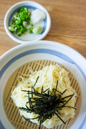 japanese White Noodles in bowl with dry seaweedの写真素材