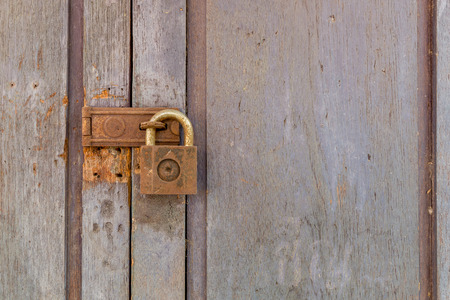 Old padlock on a old wooden door.