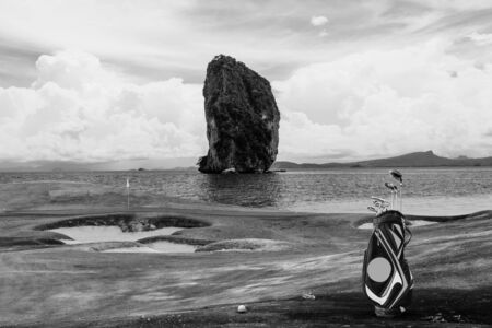 golf equipment on green and hole as background.の写真素材
