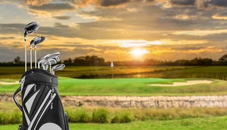 golf equipment and golf bag on green and hole as background.の写真素材