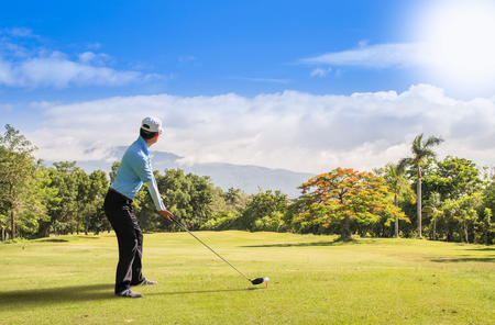 Asian golfer hit a golf ball by golf-club ( tee off  ball by driver (1-wood).の写真素材