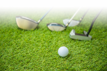 Golf ball on green and set og golf club.の写真素材