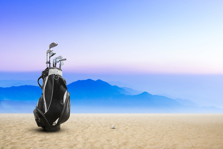 Golf bag golf ball on sand bunker sunset and blue sky as background.Golf shot from sand bunker for win and success concept.の写真素材