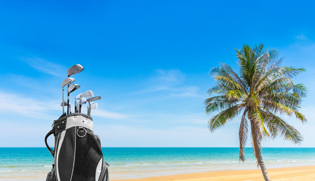 Golf bag and Golf club sea and blue sky as background . Business, Health with relaxation concepts.の写真素材