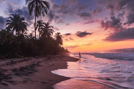 girls practicing yoga on the beachの写真素材