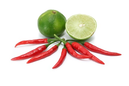 Red chili and limes isolated on whiteの写真素材