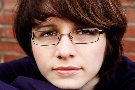 Portrait to the young girl with a thoughtful sight