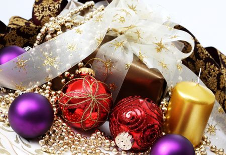 christmas gift in gold box with bow and candle の写真素材