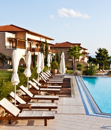 Luxury swimming pool with white fashion deckchairsのeditorial素材