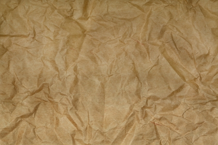 Old blank crumpled paper in yellow tone の写真素材