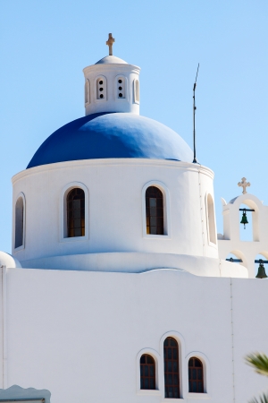 Greek orthodox church with sailboat in Santorini, Greece の写真素材