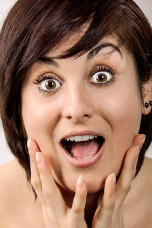 Beauty Surprised Brunette Woman isolated on White background. Beautiful Girl opening Mouth. Emotionの写真素材