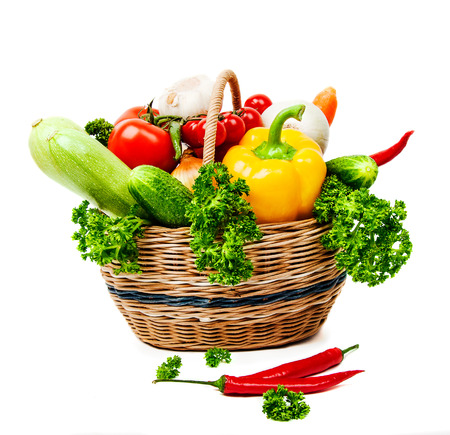 vegetables in a wicker basket on a white backgroundの写真素材