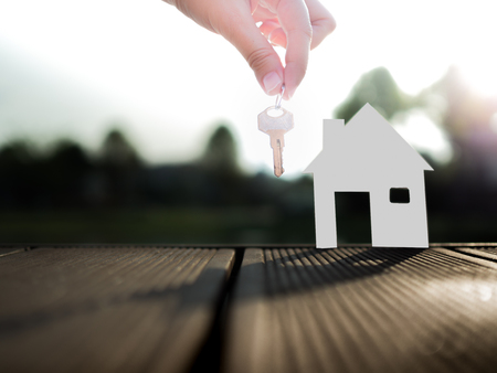 Selling real estate concept with house and key from real estate agentの写真素材