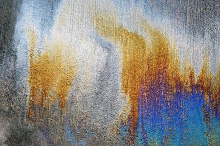 Oil spill on asphalt road background or texture 